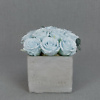 Preserved floral arrangement with light blue roses